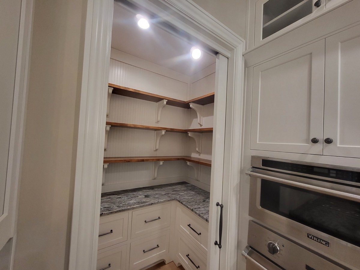 Custom walk-in pantry with adjustable shelving system